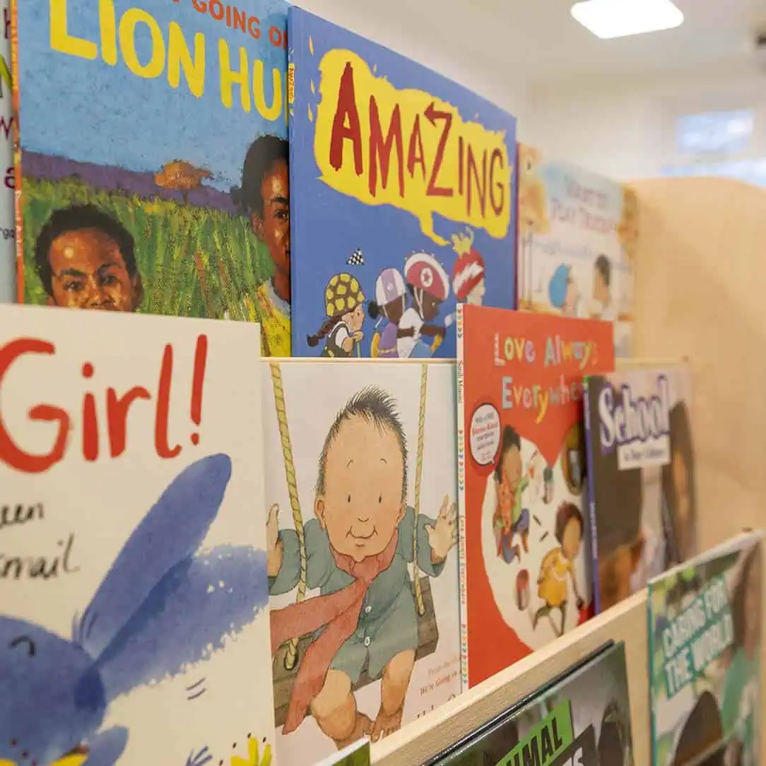 Colorful children's books displayed at Monkey Puzzle Day Nursery & Preschool Lightwater, promoting early literacy and learning in a nurturing environment.