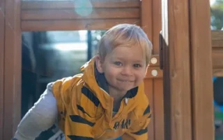 nursery child playing outside in the sun