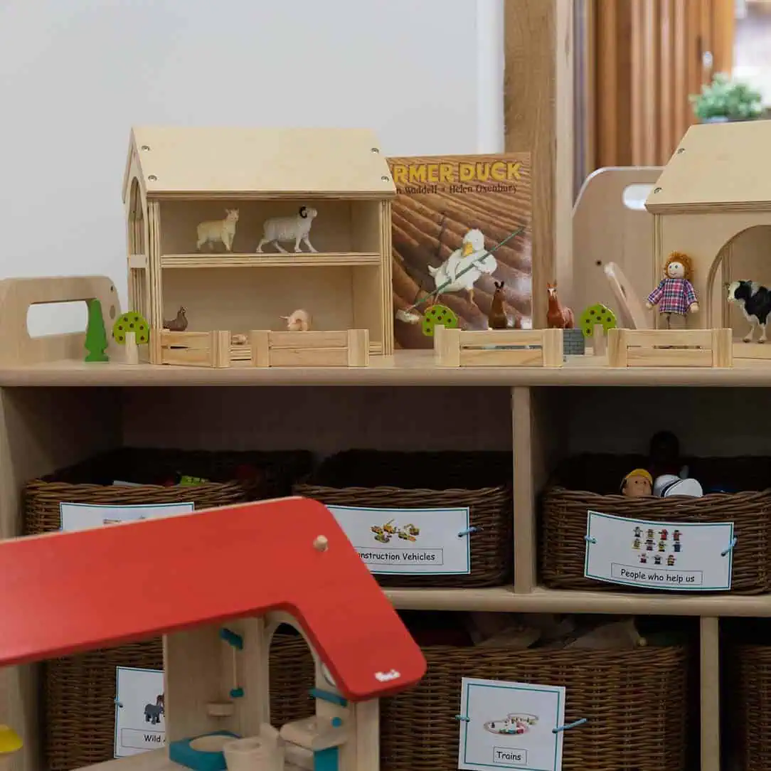 Learning resources and equipment Colorful wooden playset with farm animal figures and miniature trees at Monkey Puzzle Day Nursery & Preschool Lightwater.