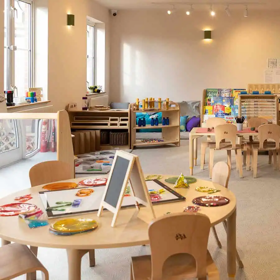 Colorful indoor children's play area with educational toys, books, and arts and crafts in the bright, inviting environment of Monkey Puzzle Day Nursery & Preschool Lightwater.