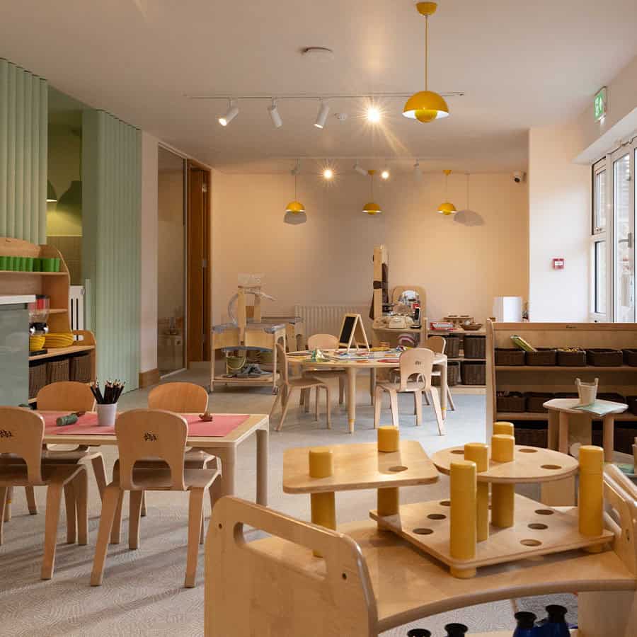 Bright and inviting indoor play and learning area at Monkey Puzzle Day Nursery & Preschool Lightwater, featuring child-friendly tables, educational toys, and cozy spaces for early childhood development.