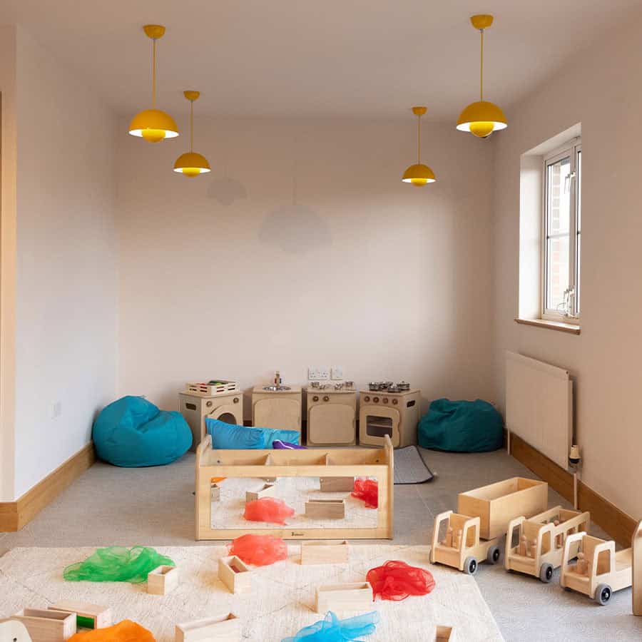 Colorful soft play and wooden toys in a bright preschool room at Monkey Puzzle Day Nursery & Preschool Lightwater, promoting early childhood development and imaginative play.